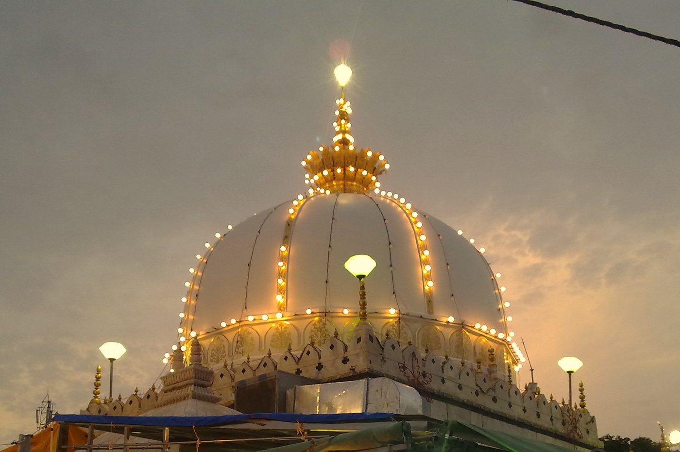 The dome of Khwaja Gharib Nawaz's Dargah illuminated at dusk